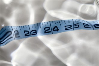 Close-up of distorted blue tape measure, New York, NY, USA