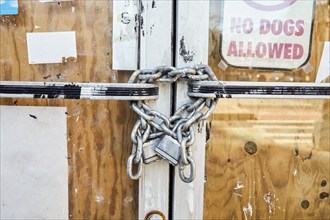 Close-up of chain and padlock on boarded up door, New York, NY, USA