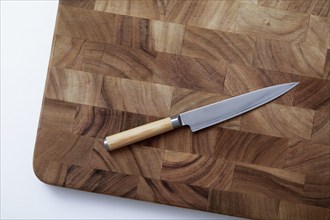 Overhead view of knife on wooden cutting board, New York, NY, USA