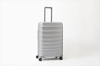 Studio shot of silver rolling suitcase, New York, NY, USA