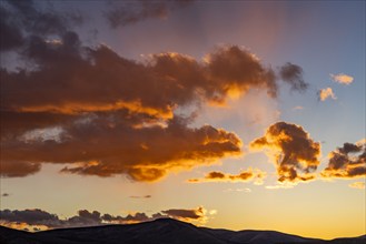 Clouds in gold sunlight at sunset, Bellevue, Idaho, USA