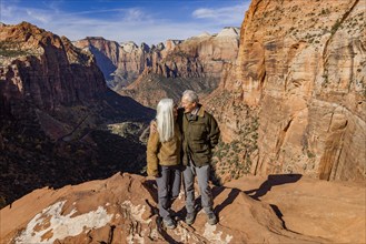 Smiling senior couple embracing at Zion Overlook, , Utah, USA