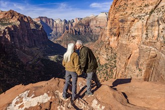 Rear view of senior couple kissing at Zion Overlook, , Utah, USA