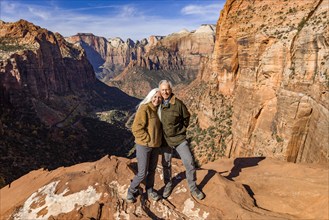 Portrait of smiling senior couple at Zion Overlook, , Utah, USA