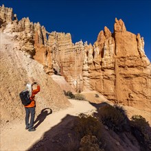 Rear view of woman taking pictures in Bryce Canyon National Park, , Utah, USA