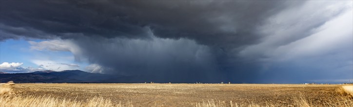 Dramatic storm clouds over field, Fairfield, Idaho, USA