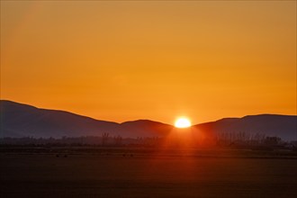 Sun setting behind hills near Sun Valley, Bellevue, Idaho, USA