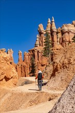 Rear view of woman with backpack hiking in Bryce Canyon National Park, , Utah, USA