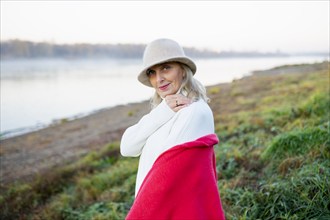 Portrait of woman in white hat on lakeshore, Omsk, , Russia