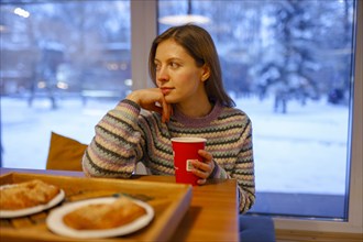 Portrait of woman having breakfast in cafe, Omsk, , Russia