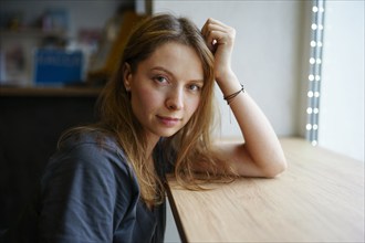 Portrait of woman leaning on window sill, Omsk, , Russia