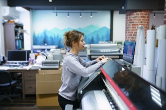 Woman working in printing studio, Omsk, , Russia