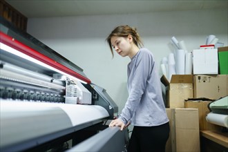 Woman working in printing studio, Omsk, , Russia