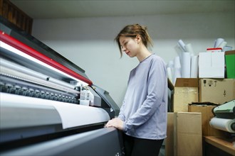 Woman working in printing studio, Omsk, , Russia