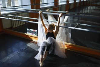 Portrait of ballerina sitting in ballet studio, Omsk, , Russia