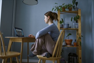 Woman using laptop at home, Omsk, , Russia