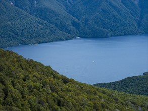 Blue lake surrounded with green hills, Te Anau, Fiordland, New Zealand