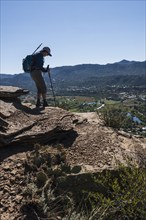 Usa, Colorado, Durango, Woman standing on ledge in San Juan Mountains, Durango, Colorado, USA