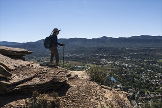 Usa, Colorado, Durango, Woman standing on ledge in San Juan Mountains, Durango, Colorado, USA