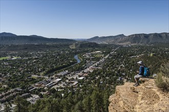 Usa, Colorado, Durango, Woman sitting on ledge in San Juan Mountains, Durango, Colorado, USA