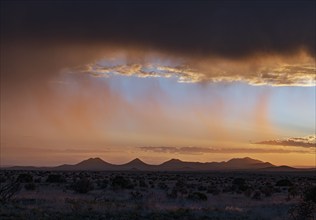 Usa, New Mexico, Santa Fe, Storm and rain over Cerrillos Hills at sunset, Santa Fe, New Mexico, USA