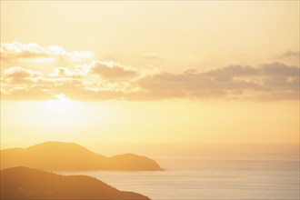 USA, United States Virgin Islands, St. John, Golden sunrise over calm Caribbean Sea, St. John,