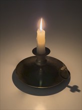 Studio shot of candle in candlestick holder, Nashville, Tennessee, USA