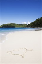 USA, United States Virgin Islands, St. John, Cinnamon Bay, Heart shape drawn in sand, St. John,