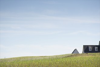 House roof visible beyond grassy hill, Nashville, Tennessee, USA, Nashville, Tennessee, USA