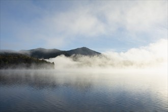 USA, NY, St. Armand, Whiteface Mountain and Lake Placid in morning mist, Lake Placid, New York, USA