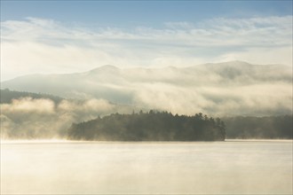 USA, NY, Island on Lake Placid in morning mist, Lake Placid, New York, USA