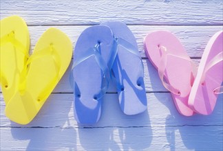 USA, Virgin Islands, St. John, Overhead view of colorful flip flops on deck, St. John, United