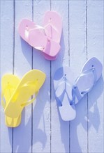 USA, Virgin Islands, St. John, Overhead view of colorful flip flops on deck, St. John, United