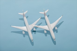 Overhead view of two model planes on blue background, New York, New York, USA