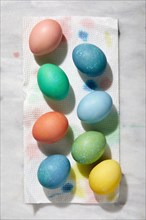 Overhead view of freshly colored Easter eggs on paper towel, New York, New York, USA