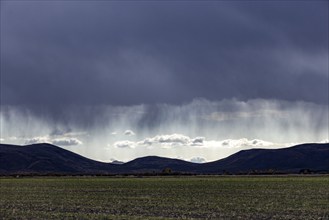 USA, Idaho, Bellevue, Ran and dramatic clouds over landscape, Bellevue, Idaho, USA