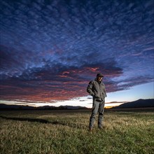 USA, Idaho, Bellevue, Farmer standing in field at sunrise, Bellevue, Idaho, USA