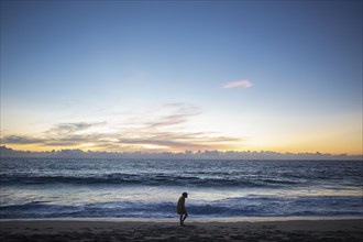 Mexico, Baja, Pescadero, Silhouette of boy on beach at dusk, Pescadero, Baja, Mexcio