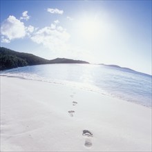 USA, United States Virgin Islands, St. John, Footprints on empty beach and calm sea, St. John,