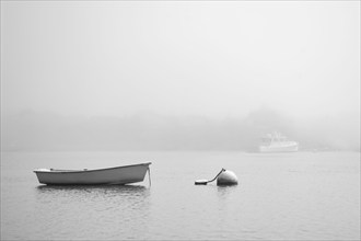 USA, Massachusetts, Nantucket, Boat and buoy on calm Nantucket Sound in fog, Nantucket,