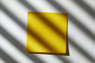 USA, New York State, New York City, Yellow blank post it note in sunlight, New York City, New York,