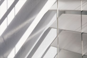 Close-up of white window blinds and shadows, New York City, New York, USA