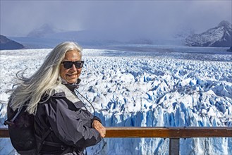 Argentina, Santa Cruz, El Calafate, Portrait of woman at Perito Moreno glacier ice formations, El