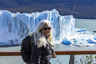 Argentina, Santa Cruz, El Calafate, Portrait of woman at Perito Moreno glacier ice formations, El