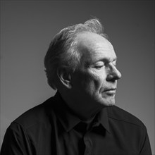 Studio portrait of serious senior man in black shirt, black and white, Bellevue, Idaho, USA