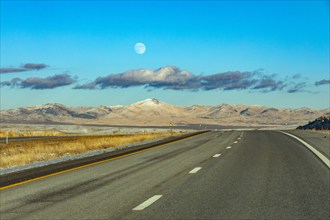 Moon and clouds over empty Interstate 80, Elko, Nevada, USA