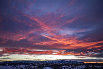 Blue and pink clouds over snow covered landscape at sunset, Fairfield, Idaho, USA