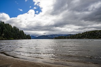 White clouds above Lake Nahuel Huapi and empty beach, Bariloche, Rio Negro, Argentina