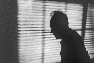 Shadow of man in profile against window blind, Bellevue, Idaho, USA