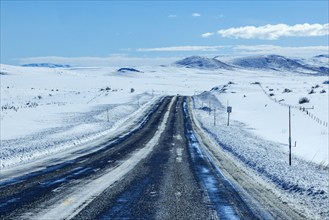 Empty interstate crossing snow covered landscape, Fairfield, Idaho, USA